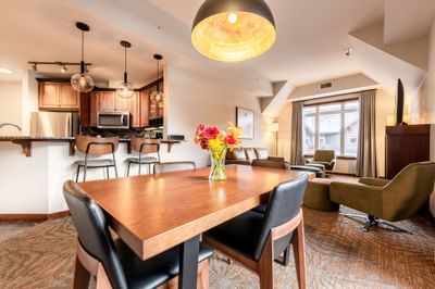 Dining table in the living room with the kitchenette in One Bedroom Deluxe Suites at Blackstone Mountain Lodge