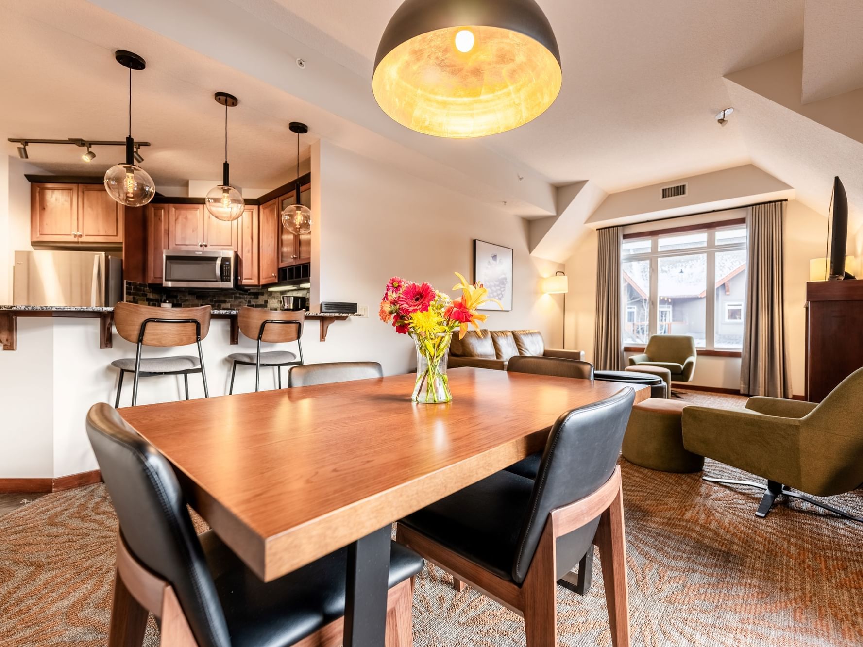 Dining table in the living room with the kitchenette in One Bedroom Deluxe Suites at Blackstone Mountain Lodge