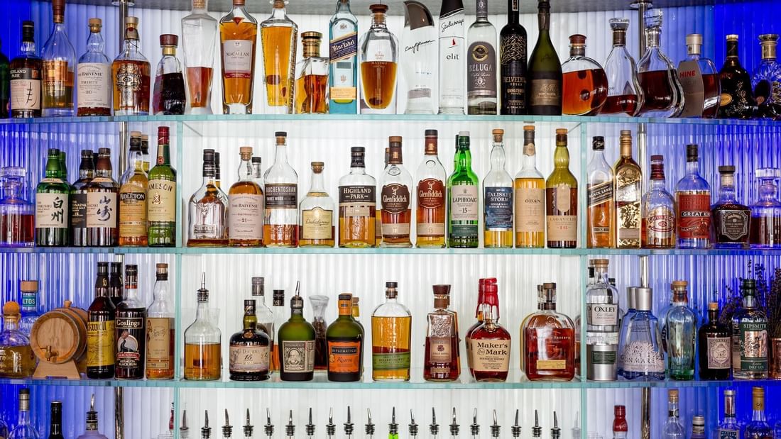 Liquor Bottles on a rack in Bar at The May Fair Hotel London