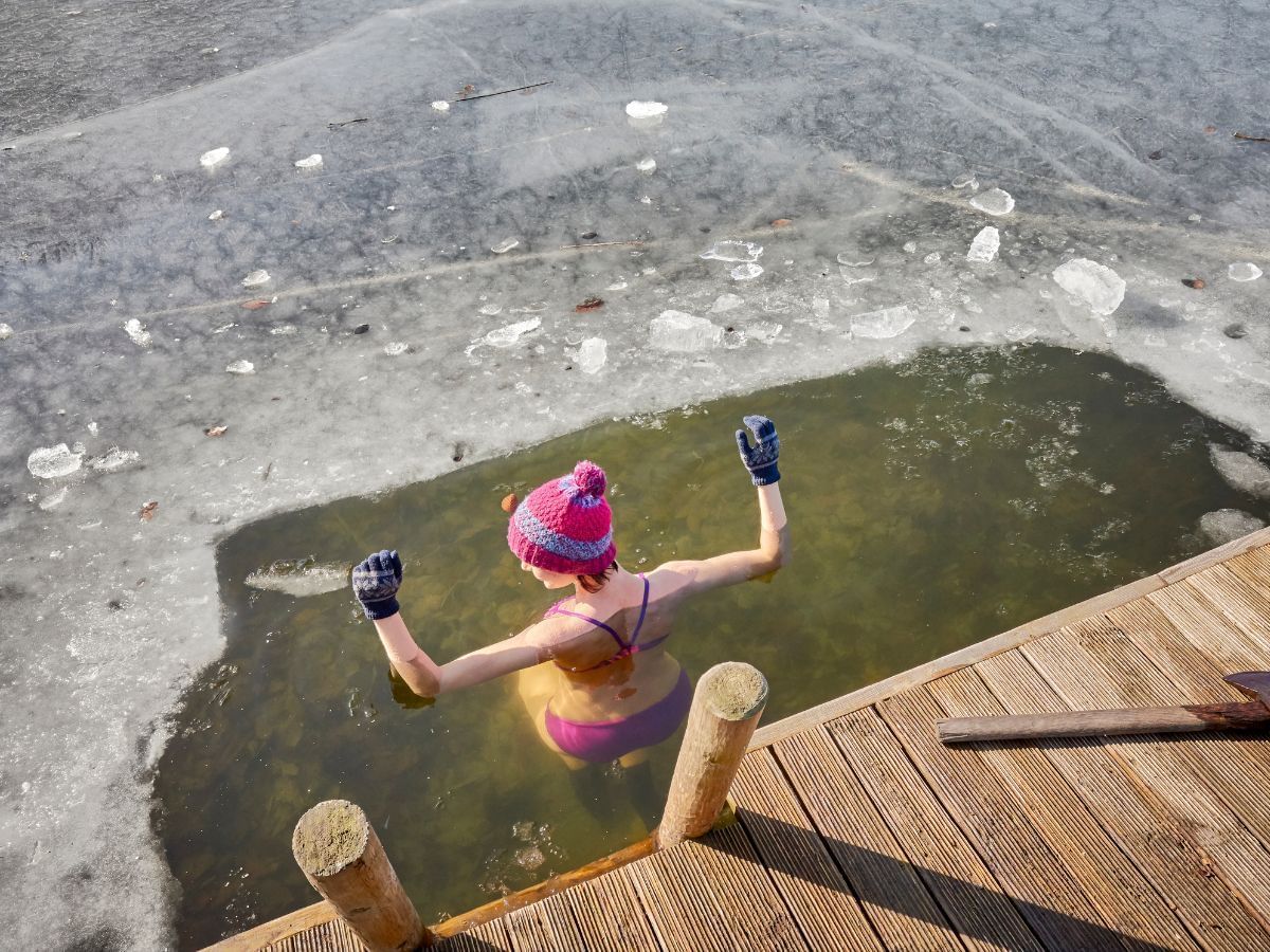 Woman having an ice water bath in a lake near Blackcomb Springs Suites