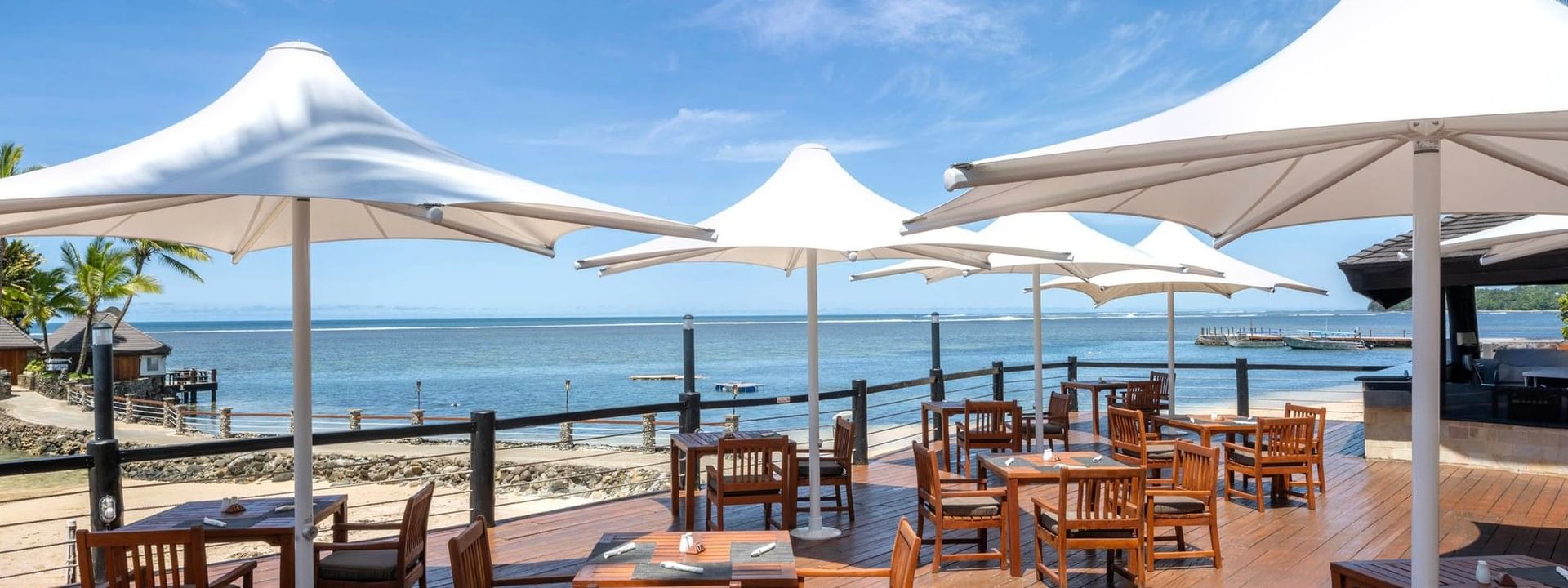 Grill & Pool Bar at Warwick Fiji Resort and Spa in Korolevu with outdoor seating by the ocean
