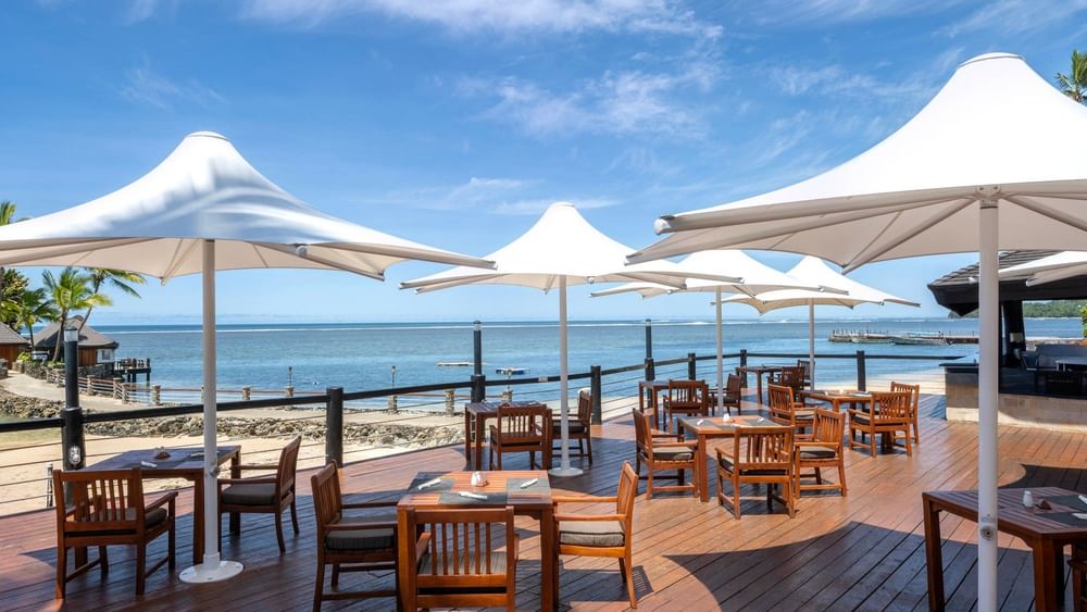 Grill & Pool Bar at Warwick Fiji Resort and Spa in Korolevu with outdoor seating by the ocean.