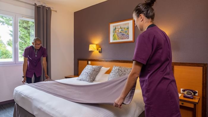 Hotel maids changing the bed sheets at Hotel Paray-le-Monial