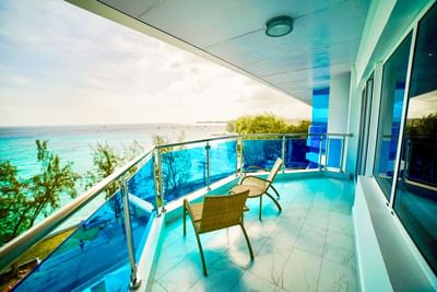 Two wicker chairs on the balcony at Abidah Hotel, capturing of a luxury small adults-only hotel in Barbados with ocean views