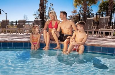 Family by swimming pool