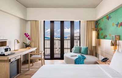 Comfy bed, working area with sofa in Deluxe Room at Eastin Ashta Resort Canggu