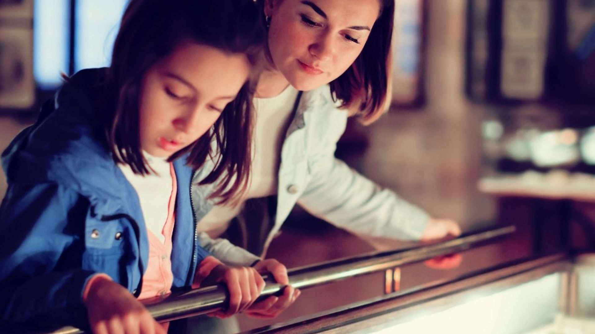 Mother & daughter exploring at museum near Village Hotels