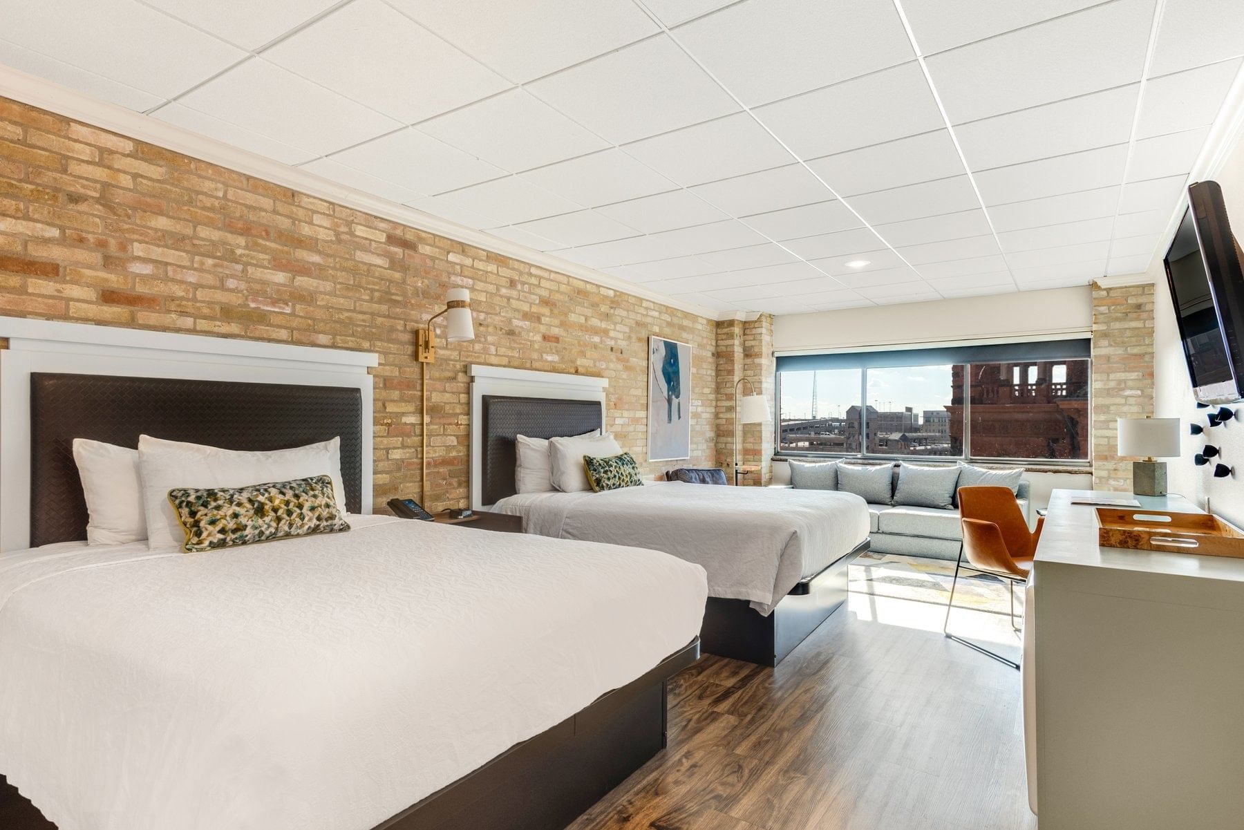 Two guest beds with desk and wall mounted TV