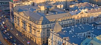 Aerial view of the Polonia Palace Hotel and streets with vehicles during the sunset