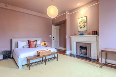 Luxury King room with fireplace and a hanging globe light at The Ashbrook Hotel, featuring Frankfort Kentucky lodging
