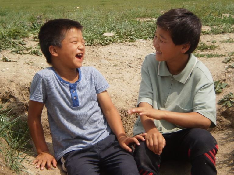 Two kids smiling with each other at Royal on the Park Hotel