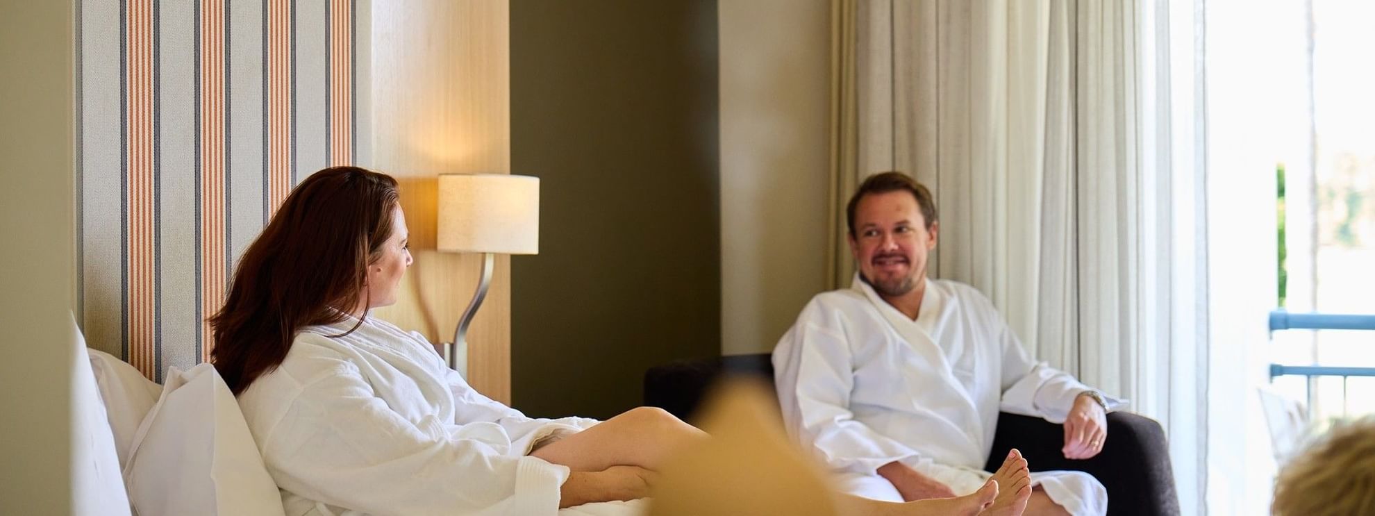 Couple in robes sitting on a bed, aromatherapy 