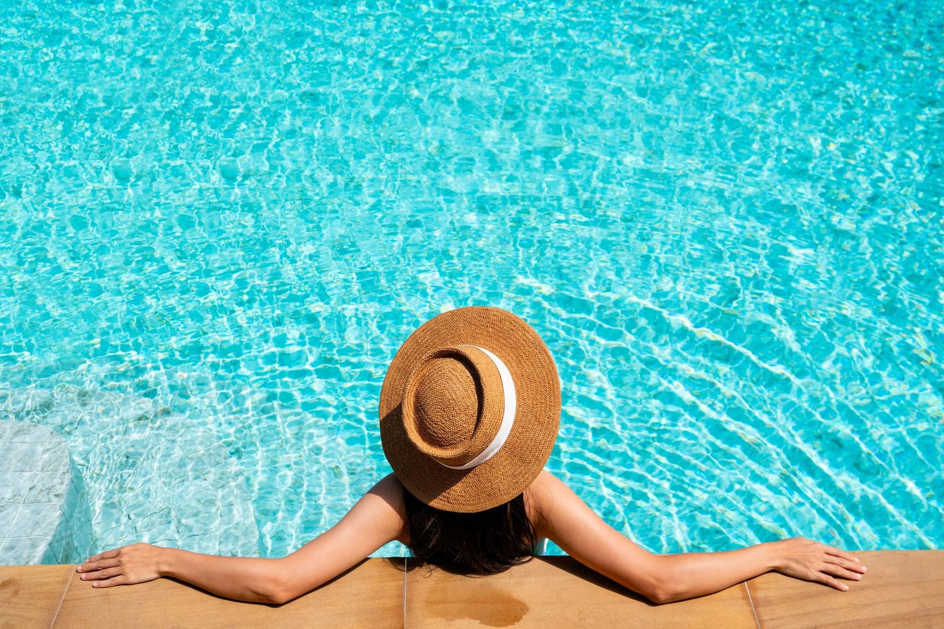 Lady in a straw hat by the edge of the rooftop pool, Bangkok at Paradox Bangkok Sukhumvit