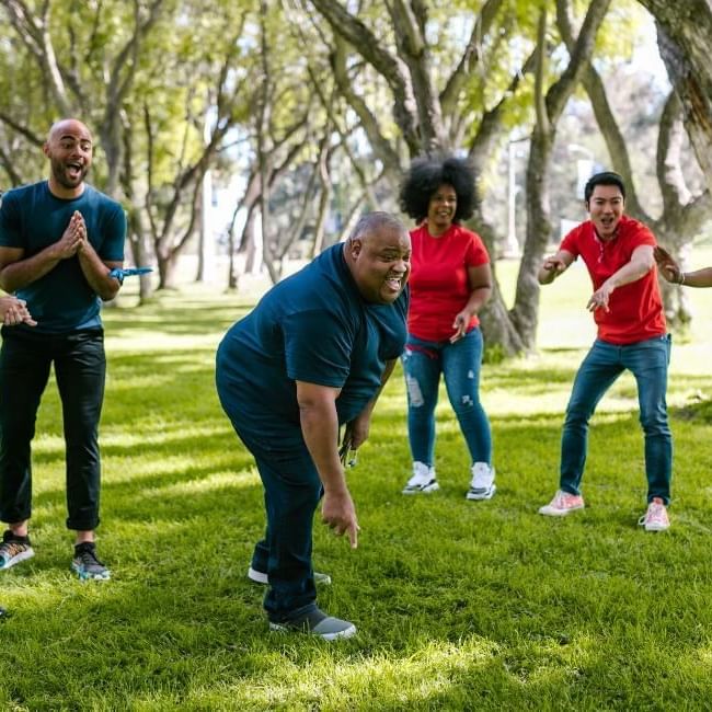 Employees cheering during team building event featuring our article on 