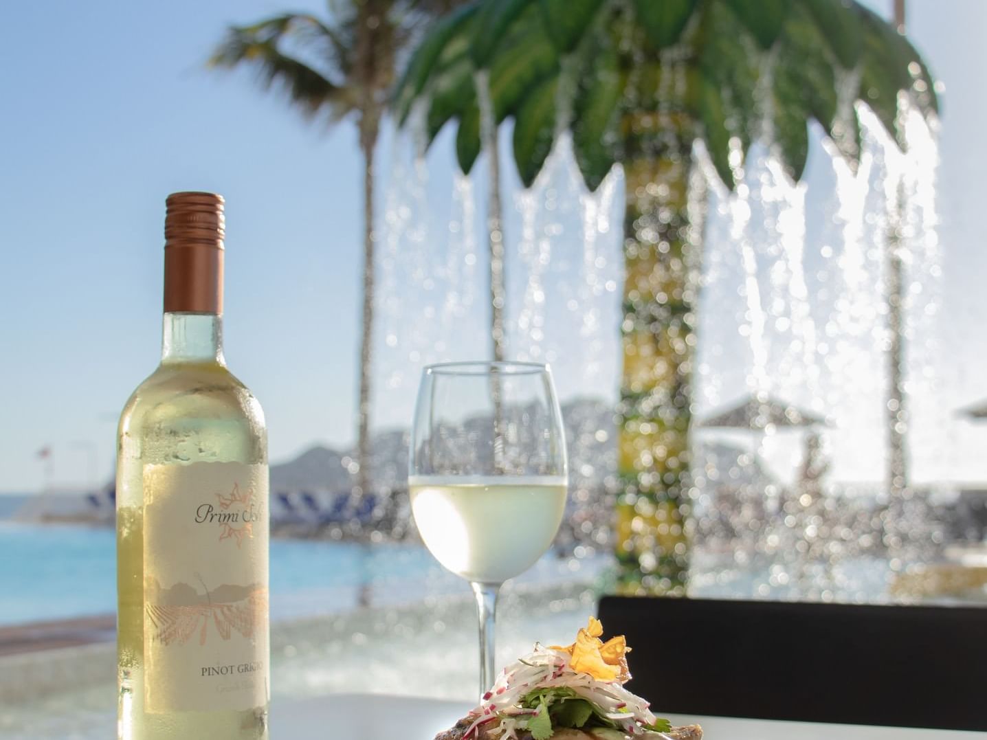 Champagne bottle & glass in restaurant, Viaggio Resort Mazatlan