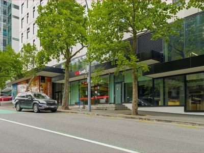A modern building with glass facades and trees in front named Mayoral Drive Student Accommodation.