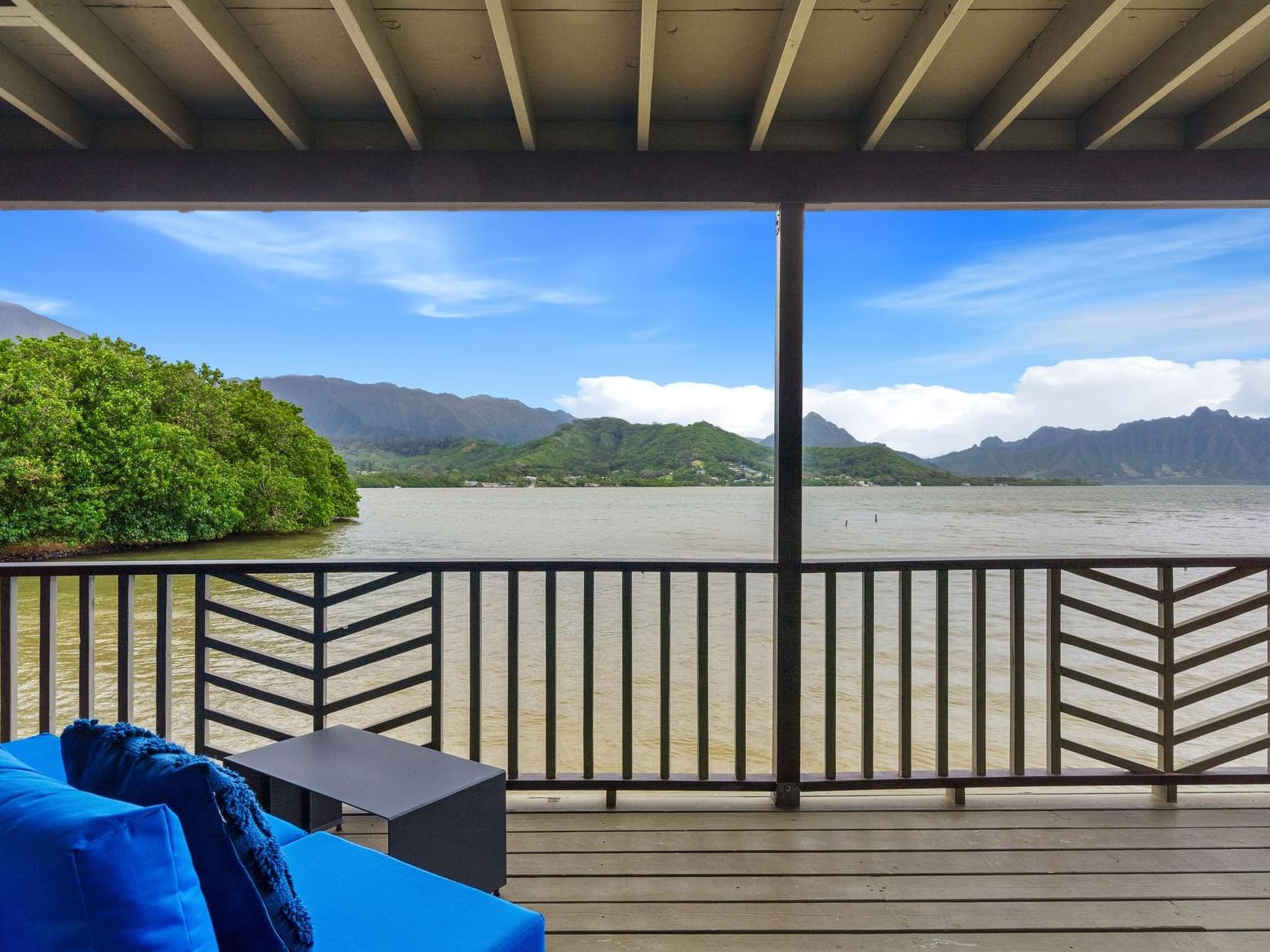 Balcony lounge area in One-Bedroom Waterfront Cottage at Paradise Bay Resort