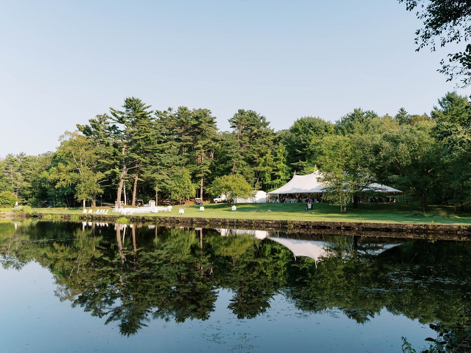 Diamond's Edge by a tranquil lake, surrounded by lush greenery at Portland Harbor Hotel