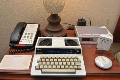 Nightstand with appliances in a room at Rosen Inn Closest to Universal