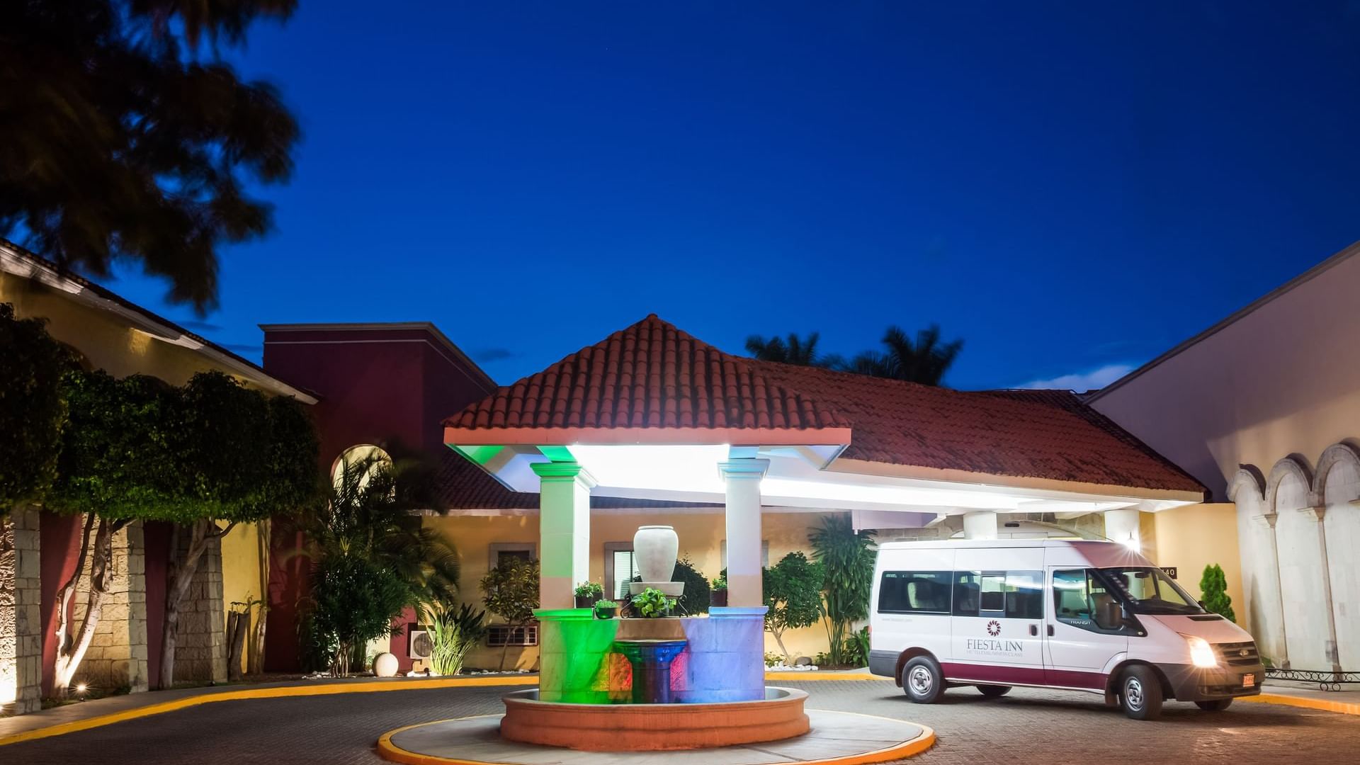 A hotel transport parked at an entrance at Fiesta Inn Oaxaca