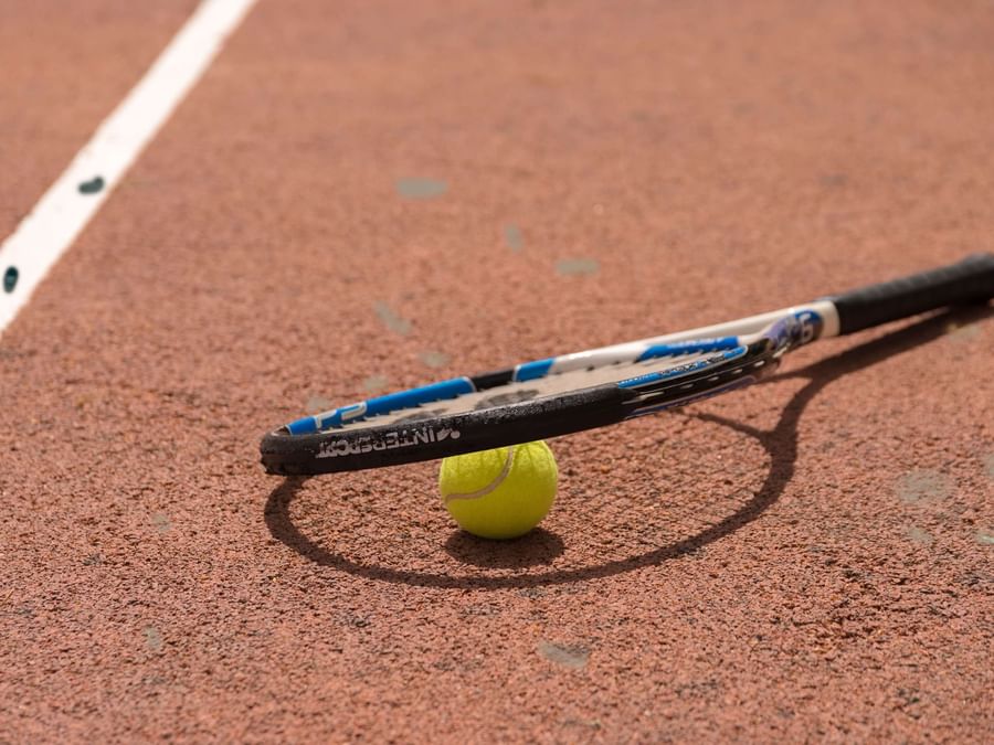 Tennis racket & ball on the tennis court near Villa Borghese