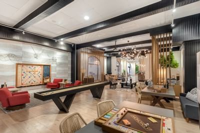 Gaming area featuring a large Scrabble board and Monopoly game setup in the lounge at The Riverwalk Plaza Hotel
