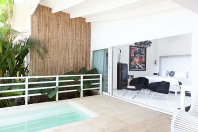 Modern outdoor space with lush greenery and a peek into Romantic Suite Beachfront with Pool at Le Cameleon