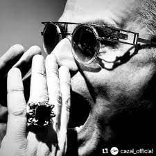 A black and white poster of a man wearing glasses