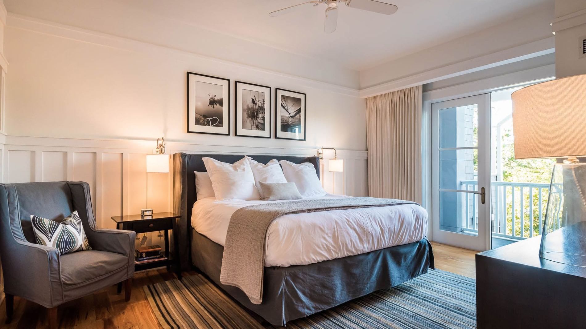 Comfy king bed with sofa chair in Premium Resort suite at Watersound Inn