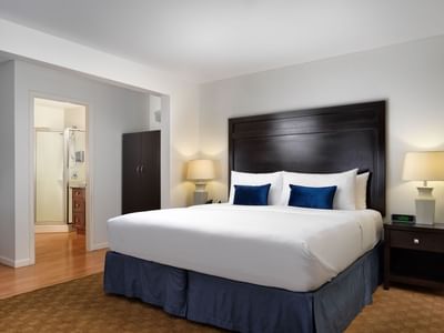 Bedroom featuring bedside lamps & modern interior in Grand Dorset Suite at Huntingdon Manor