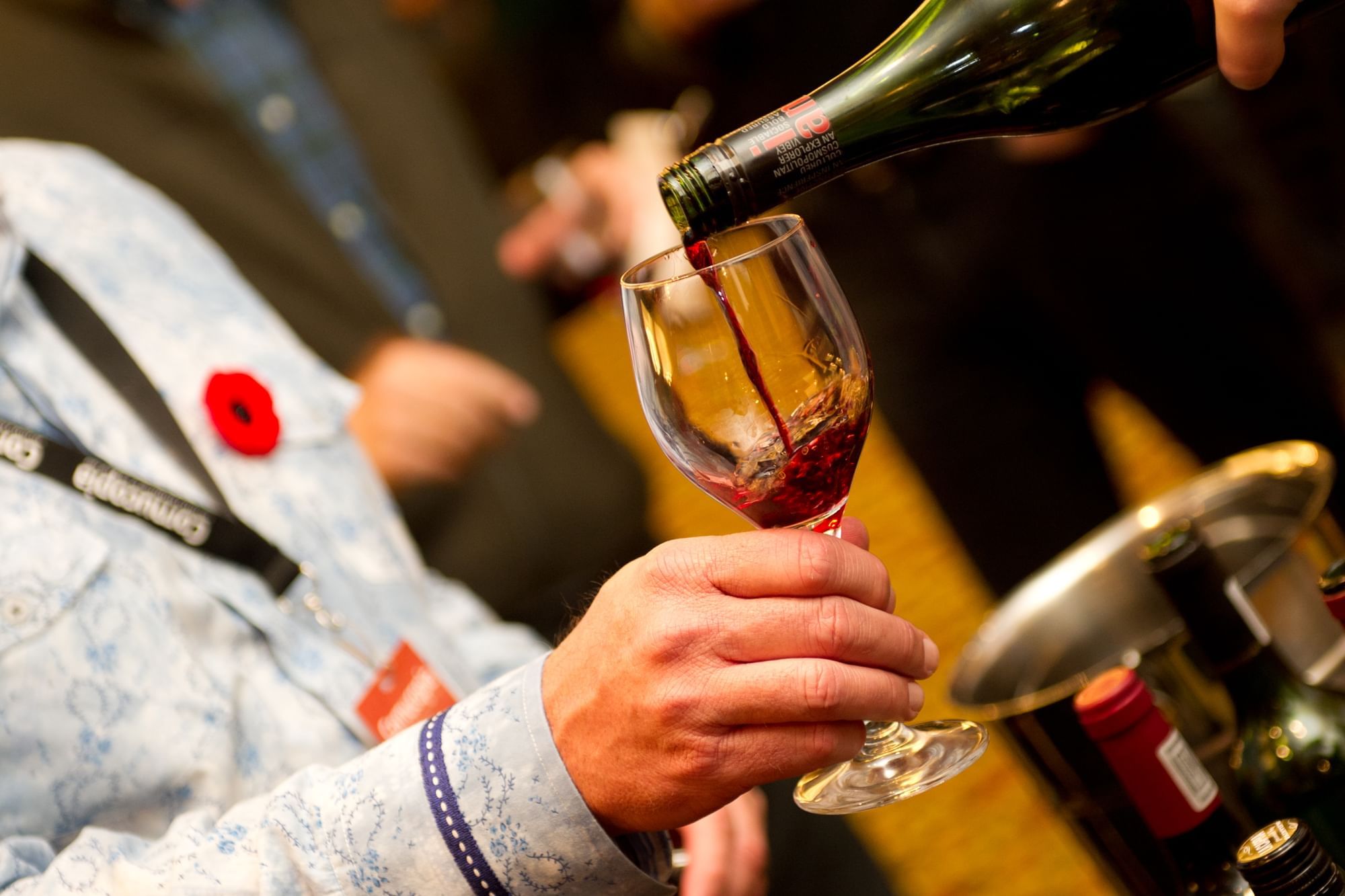 Close-up of wine pouring into a glass at Whistler Cornucopia near Blackcomb Springs Suites