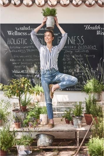 A woman standing by one leg & posing at Marbella Club