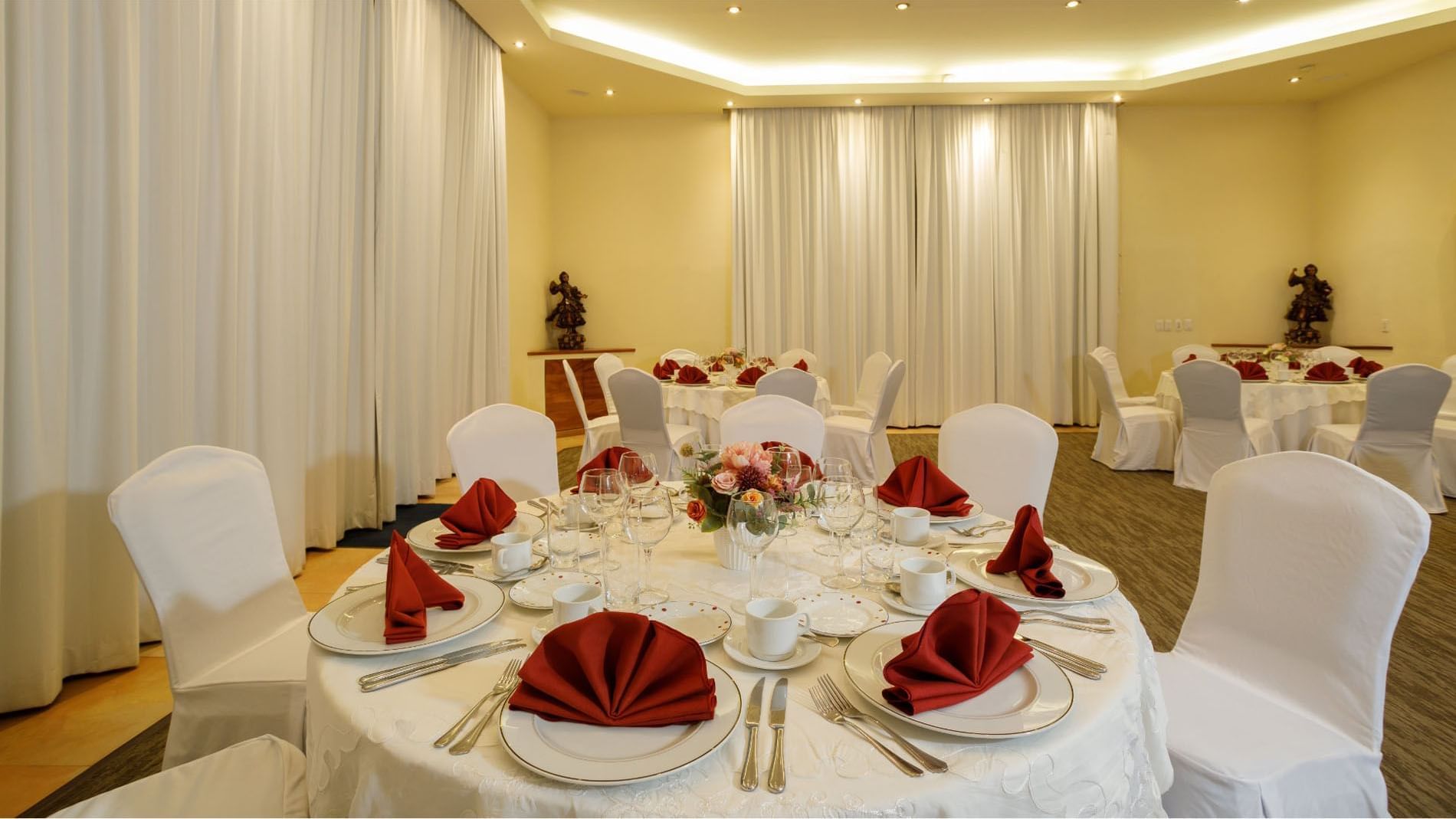 Well lit Salón Cuatro Estaciones featuring elegant table settings and white drapery at Quinta Real Guadalajara