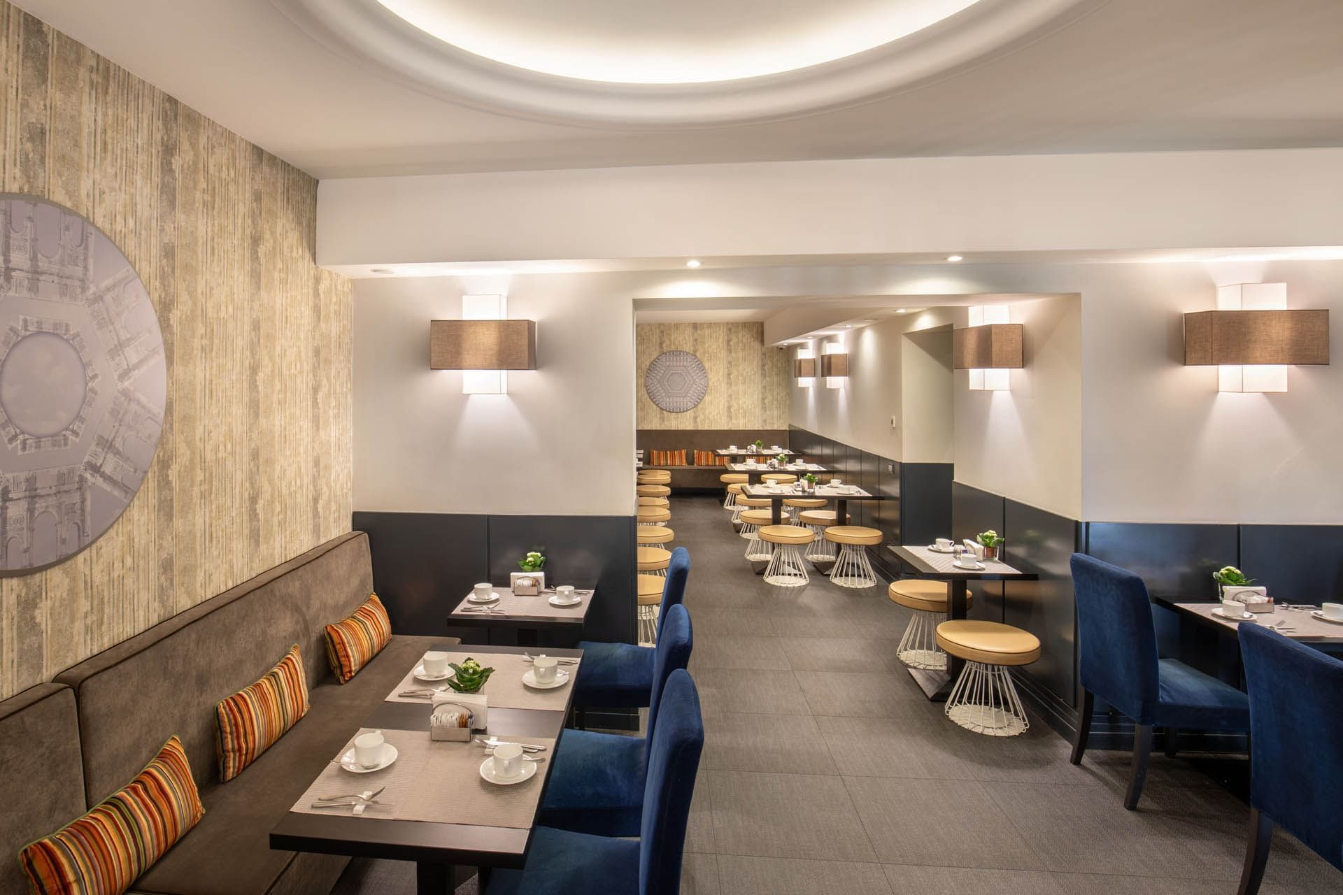 Dining area with stylish furniture, featuring tables set for tea and decorative plants at The Republic Hotel