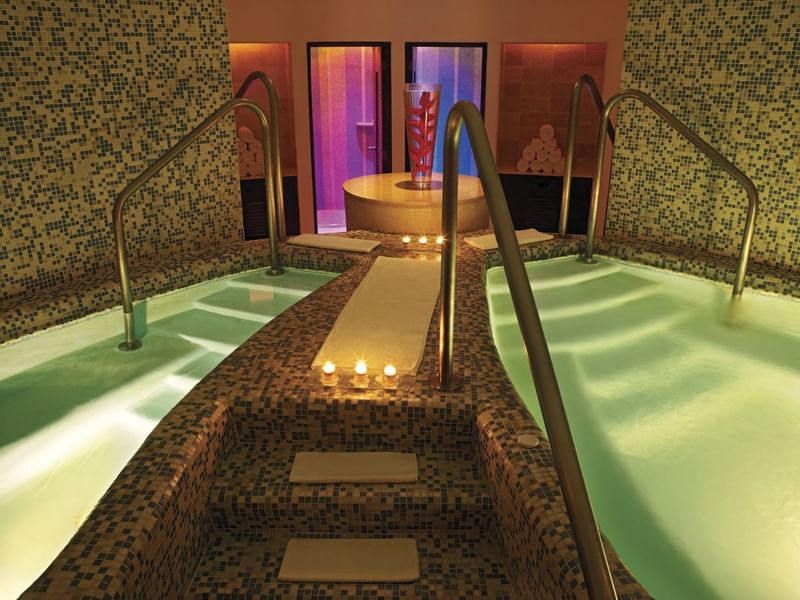 Illuminated spa with stairs to bath area and amenities at Live Aqua Cancún