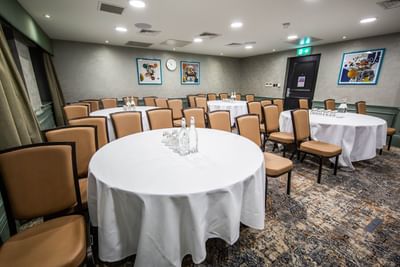 Professor Brian Boffey's room at The Met Hotel Leeds, England, featuring round tables and brown upholstered seating