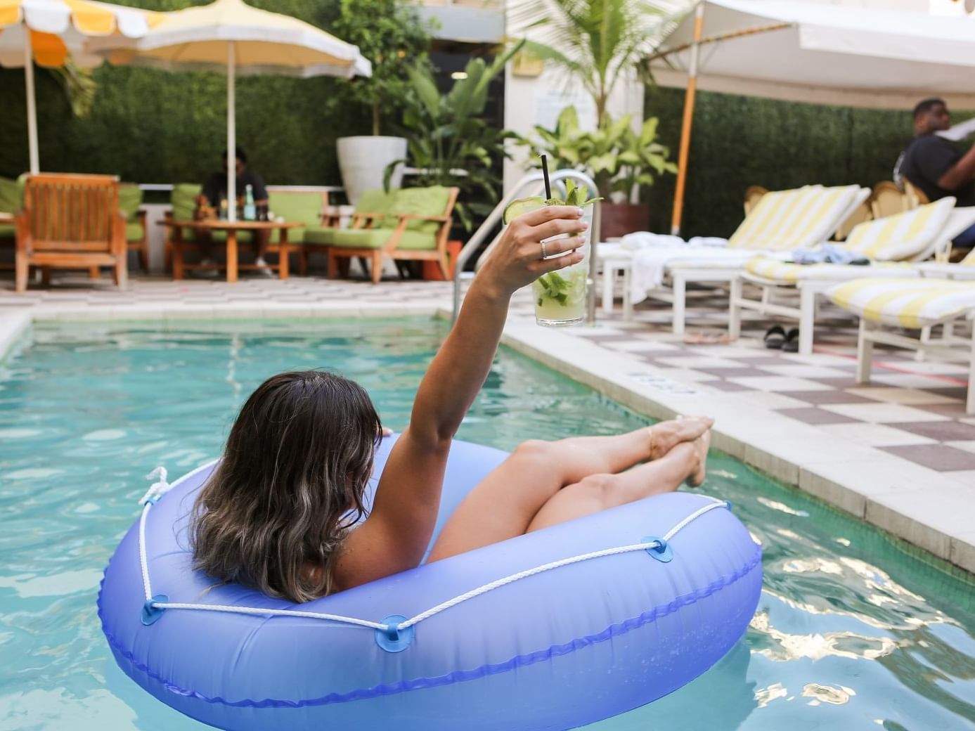 girl in the pool with a drink