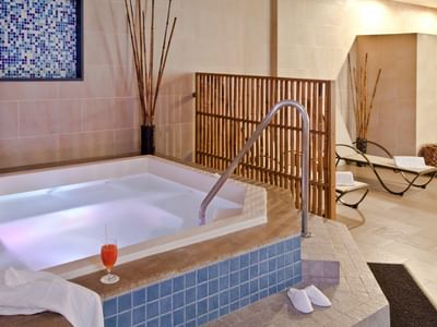 Prime Spa featuring elegant blue tile accents and cozy lounge chairs for ultimate relaxation at Habitel Prime Hotel