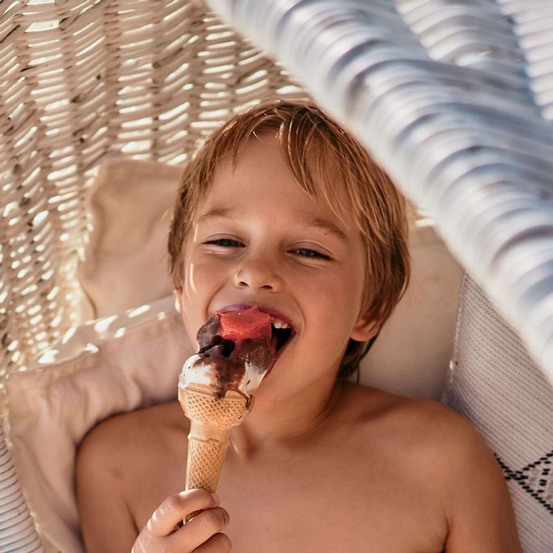 Close-up of a little boy eating ice cream, Falkensteiner Hotels
