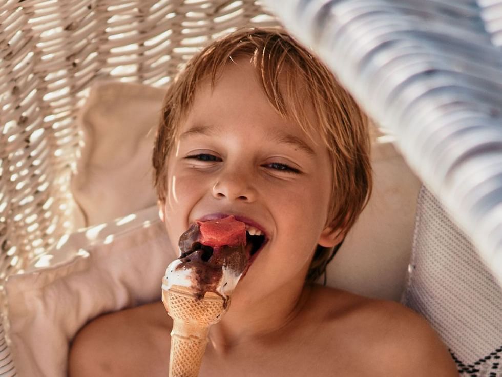 Photo of boy enjoying an ice-cream at Falkensteiner Hotels