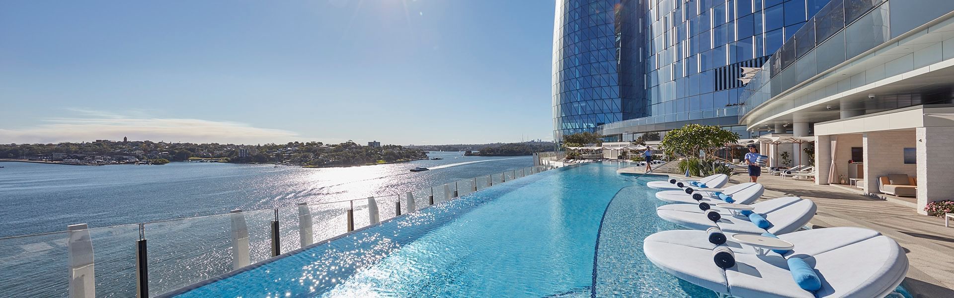 Outdoor pool with sun beds at Crown Promenade Melbourne