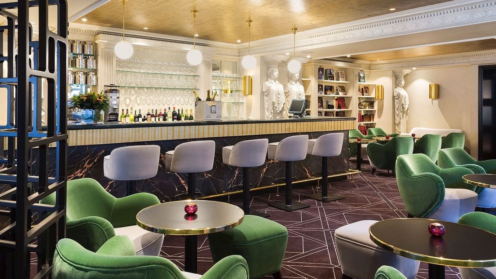 Stylish marble bar with green velvet seating and classic statues at Hotel Barsey by Warwick