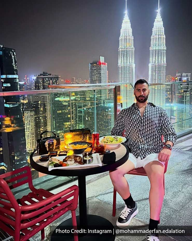 Man enjoying a meal on the rooftop of Imperial Lexis Kuala Lumpur, Restaurant with KLCC view at night