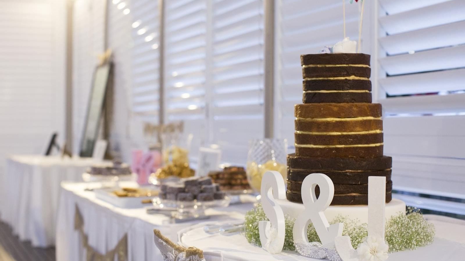 Wedding cake with chocolate and vanilla layers, accented by decorations at Mercure Hotel Townsville
