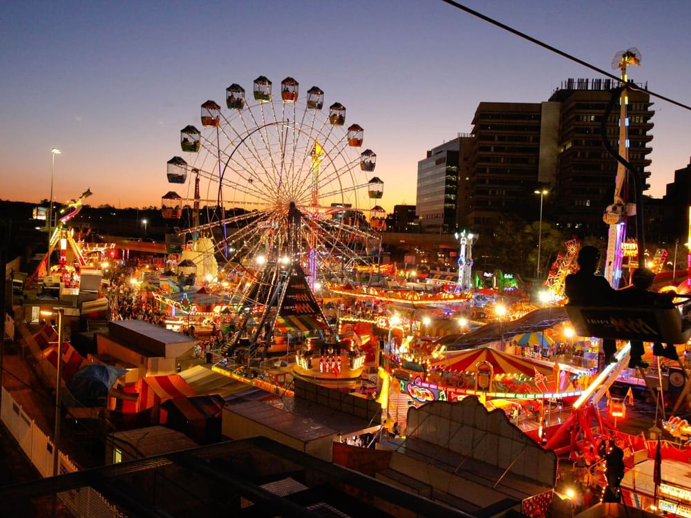 Illuminated carnival with ferris wheel in EKKA near Sofitel Brisbane Central