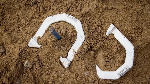 Close-up of Horseshoes on the sand, featuring the Horseshoe game at Cove Pocono Resorts
