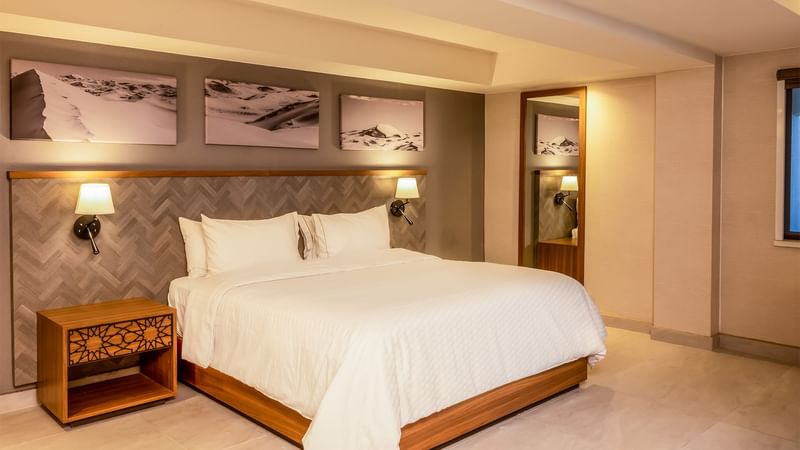 Large comfy bed in hotel room at Gamma Ciudad Juarez