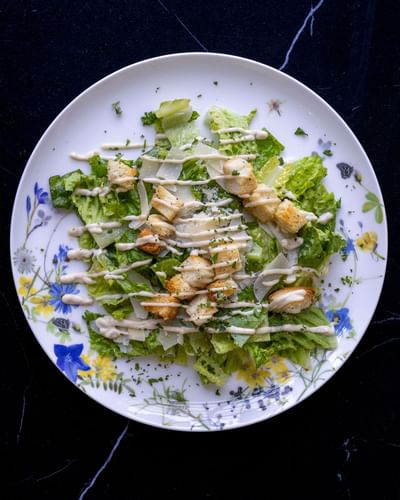 Caesar salad with grilled chicken and croutons served at The Ashbrook Hotel, one of the best hotels in Kentucky