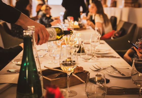 Pouring wine at dinner in The Granary La Suite Hotel