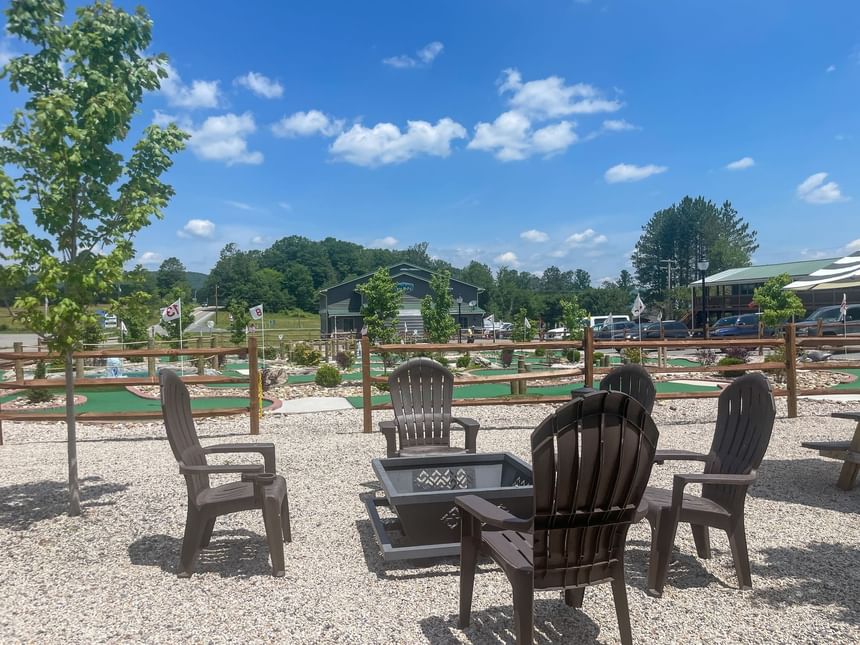 Outdoor chairs & firepit area with mini golf course view at The Inn at Canaan